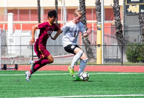 Cal State LA midfielder, Tim Klefisch, fends off Toro, Julian Guerrero during their game against Cal State Dominguez Hills at Cal State LA.