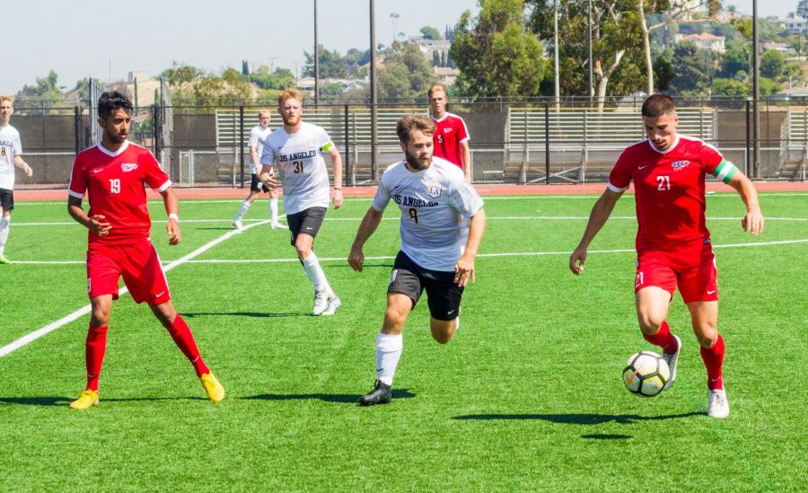 Cal State LA soccer player is aiming for the ball as the Concordia Eagles are playing offensively