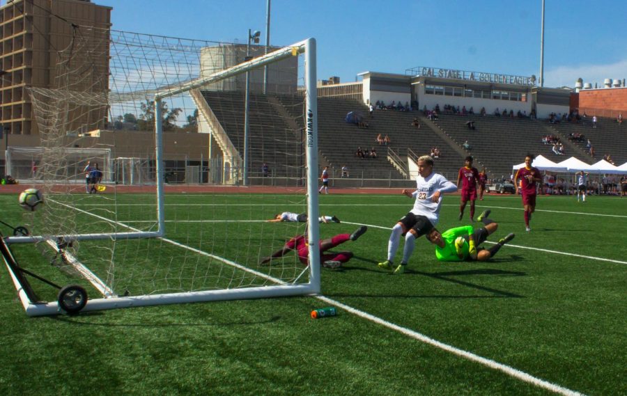 Cal State LA Golden Eagles shoots a soccer ball inside the goal line, scoring a score!