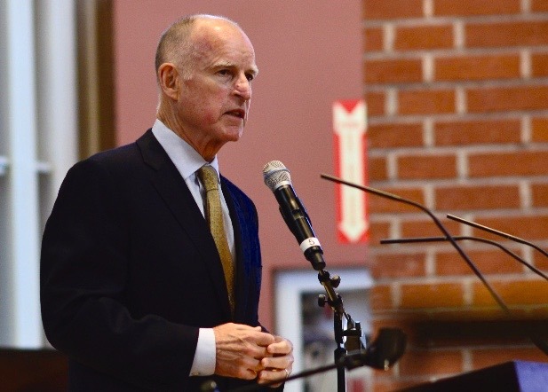 Jerry Brown, governor of the state of California is speaking in front of a podium