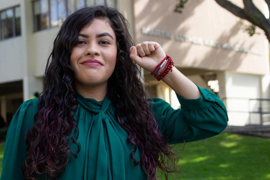 Claudia Rueda poses in front of King Hall at Cal State LA