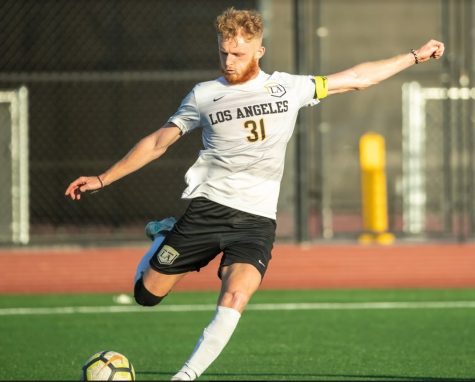 Golden Eagle midfielder, Samuel Croucher, a graduate student, crosses the ball at Cal State LA's home field.