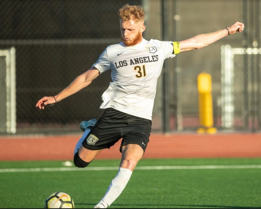 Golden Eagle midfielder, Samuel Croucher, a graduate student, crosses the ball at Cal State LAs home field.