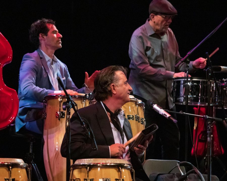 Andy Garcia performing on the drums with his band on stage