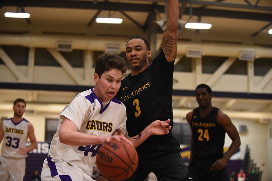 Golden Eagles forward, number 3, Jihad Woods (right) defends the Gators number 44, center Ryne Williams (left) during the opening round of the 2019 CCAA tournament at San Francisco State Universitys Main Gym at Don Nasser Plaza. Photo courtesy of San Francisco State Athletics Department.