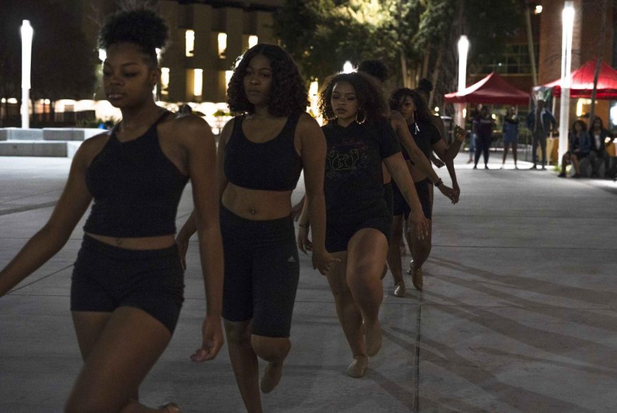 Performers walking off stage at the end of their routine that they performed at the Show Up Show Out event on Friday in the U-SU Plaza.