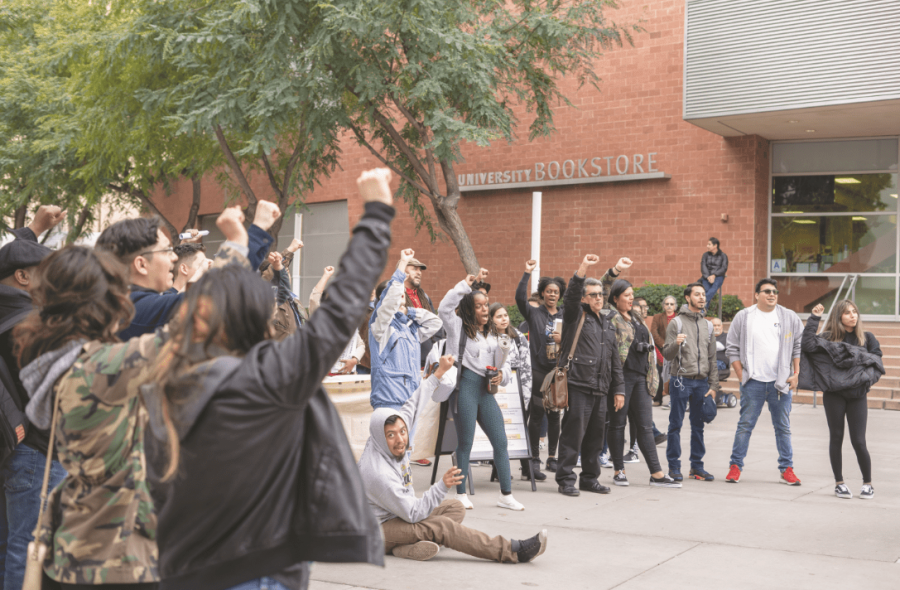 Protestors with fists held high as a symbol of unity and strength for the students of Cal State L.A.