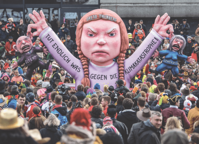 Picture of a German lady mannequin in a crowd of people.