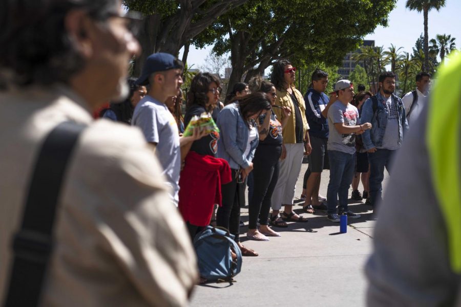 Students gather in a Healing Circle at the Migrants are Beautiful event next to the Golden Eagle Statue last Tuesday at Cal State L.A. 