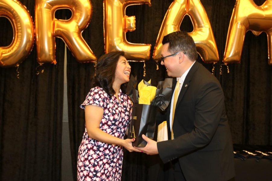 Henoc Preciado (Director of the Erika J. Glazer Family Dreamers Resource Center), providing Keynote Speaker Cristina Jimenez a thank you gift after she delivered her speech.