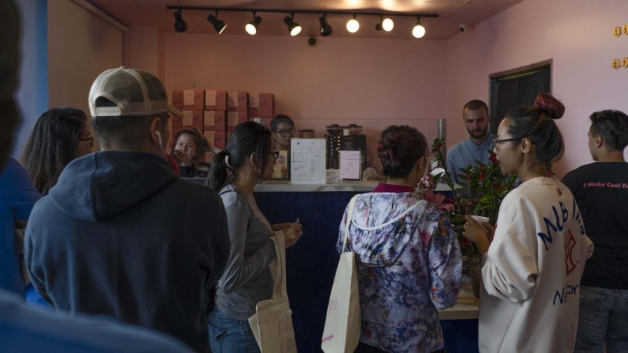 After a long line, customers again wait patiently after reaching the register to receive their free doughnuts this past Saturday