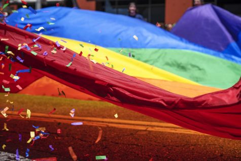 One of the more colorful parts of the 2019 Pride Parade was that of a huge rainbow flag trailing a truck as it was waved and doused with confetti.