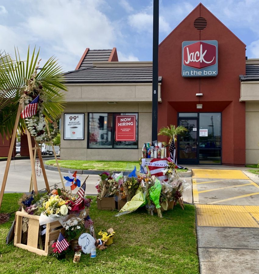 A memorial site for LA County deputy, Joseph Gilbert Solano, is placed at the entrance of the Alhambra Jack in the Box where the shooting occurred