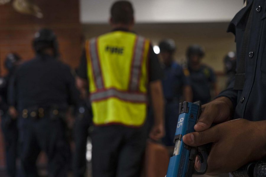 An officer stands guard to maintain the "warm zone" as paramedics are deployed to treat volunteer victims during an active shooter drill that took place this past Wednesday at Cal State L.A. in the Biological Sciences building. 