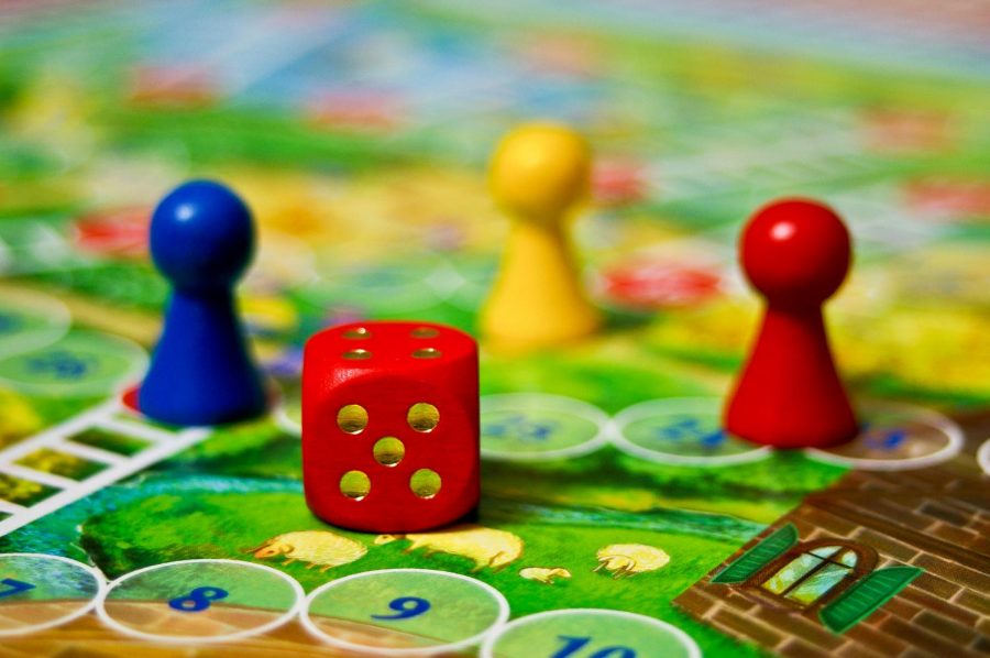 Set pieces of Snakes and Ladders board game. The Cal State LA library is now offering board games for students to use.