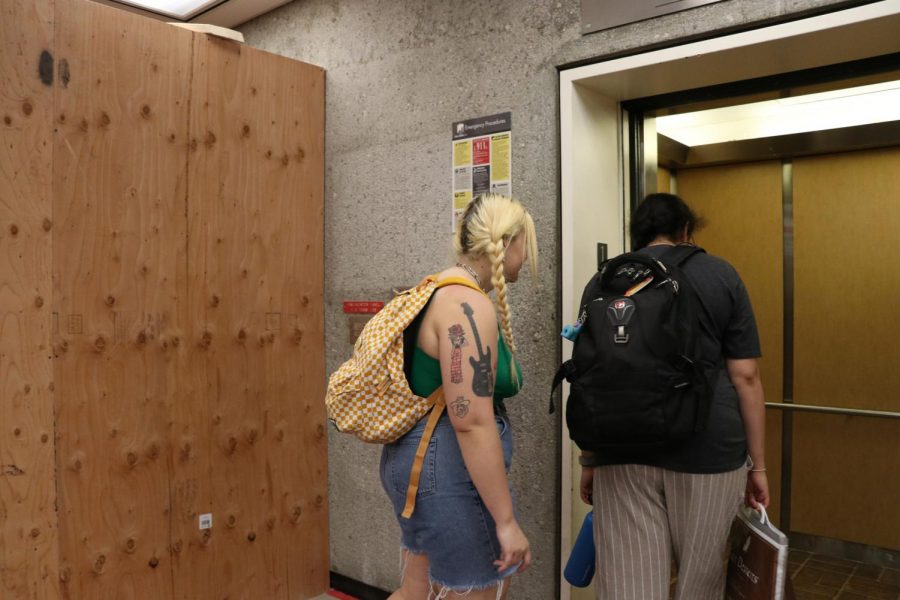 Zoe Little (left), and Abhiravi Charathram (right), board the second elevator in the North library due to ongoing maintenance of the other library elevator.