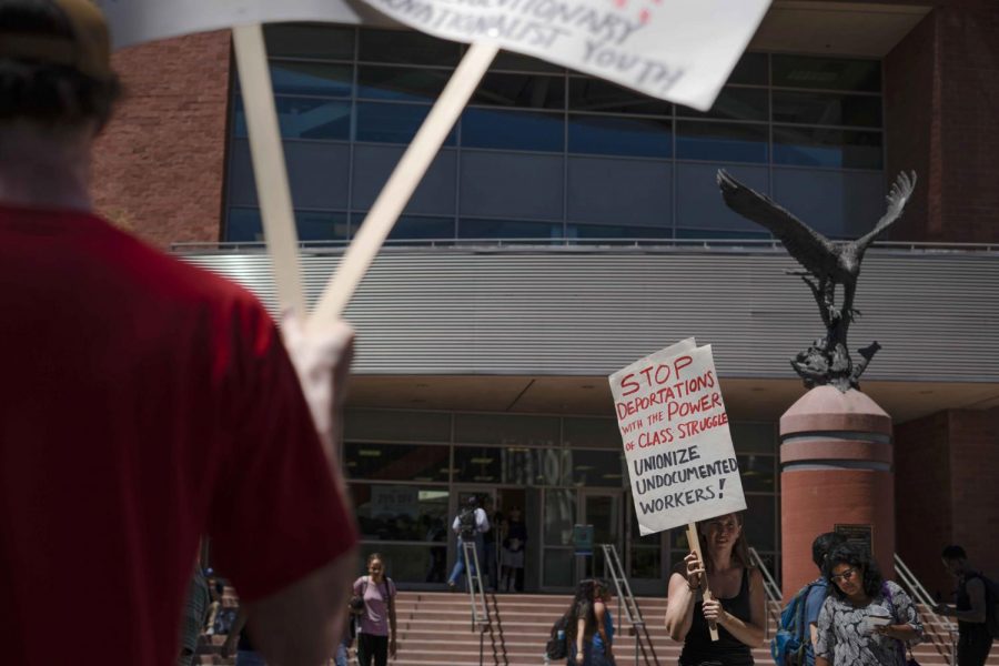 Will T. (left) and Viviana Capitran (right) with the Revolutionary Internationalist Youth who held a rally against I.C.E. raids last Thursday as the two gathered signs of protest to pass around at Cal State LA.