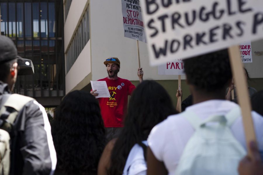 Will T. (middle), a member with the Revolutionary Internationalist Youth organization, spoke out against I.C.E. raids and other immigration issues at a rally last Thursday next to the Golden Eagle statue at Cal State LA.