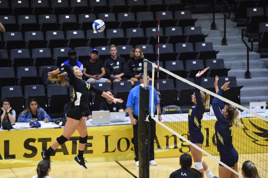 Alejandra Negron (20) reaches to hit the ball. The Cal State LA womens volleyball team defeated UC San Diego with a score of 3-0.