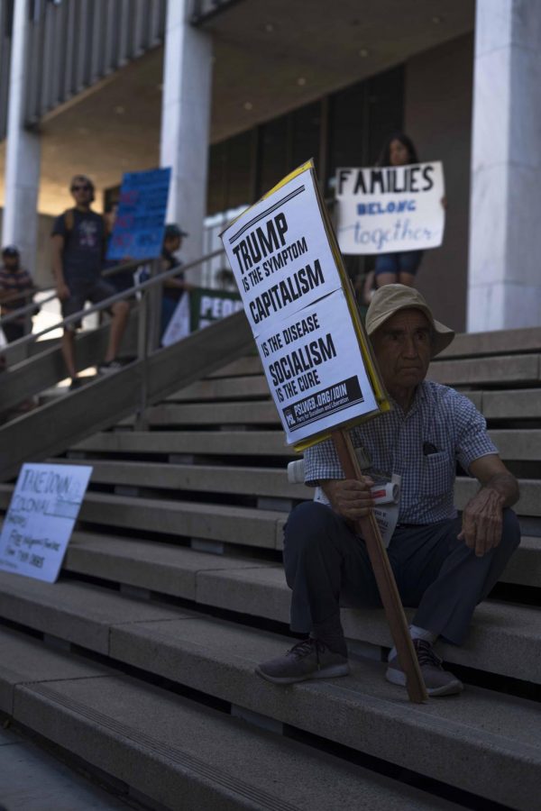 Resting at the steps of the US General Services Administration building in Los Angeles, protestors ended their march with speeches, signs, and chants against ICE deportations.