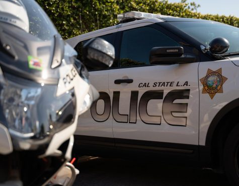 A police motorcycle and a vehicle parked at the Public Safety lot.