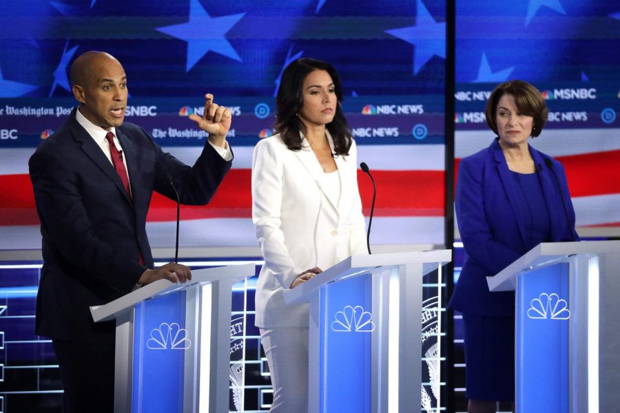Democratic presidential nominees, Cory Booker (left), Tulsi Gabbard (middle), and Amy Klobuchar (right), at the Democratic Presidential Debate on November 20, 2019.