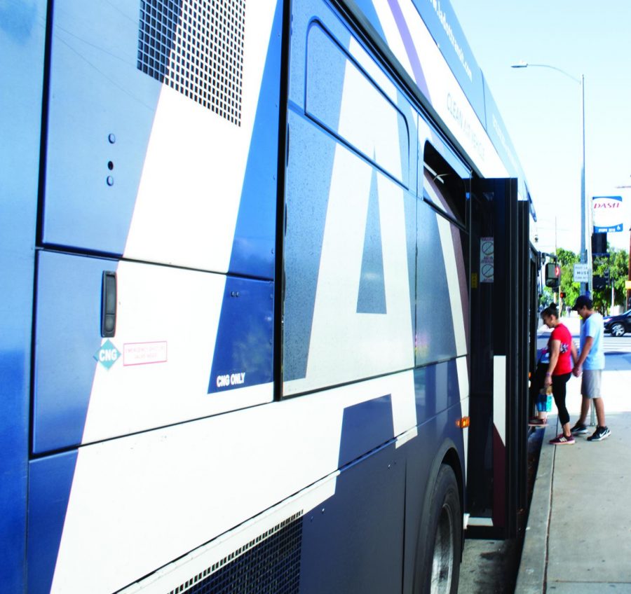 A mother and son board the DASH bus to take a trip through the neighborhood.