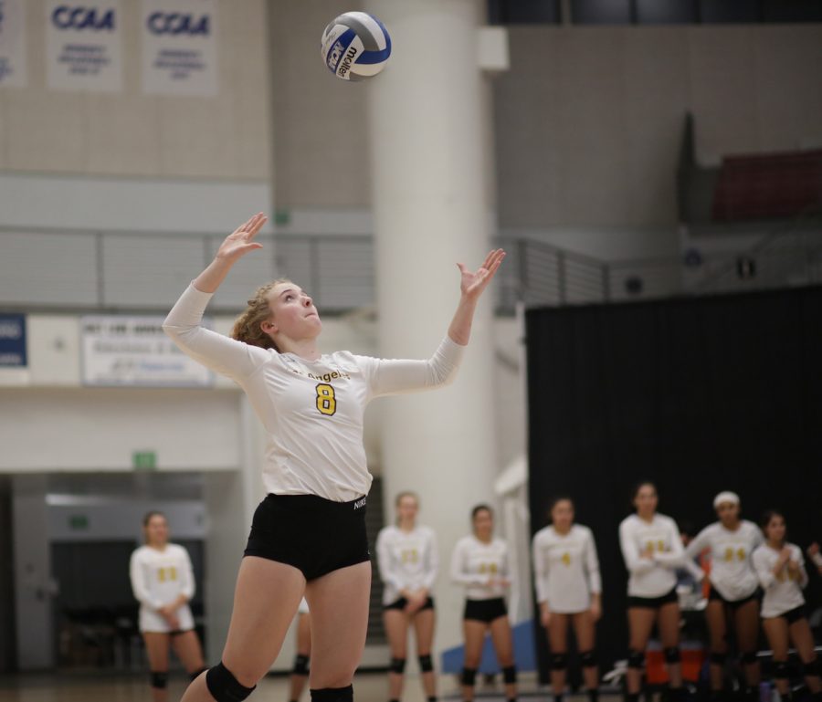 Shea Mcgovern (8) reaches out for a score against Sonoma State volleyball players. The game was a victory for Golden Eagles with a score of 3-1.