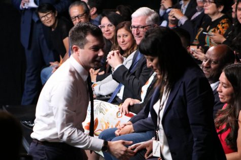 Mayor Pete Guttigieg is shown shaking hands at the presidential candidates forum on campus.