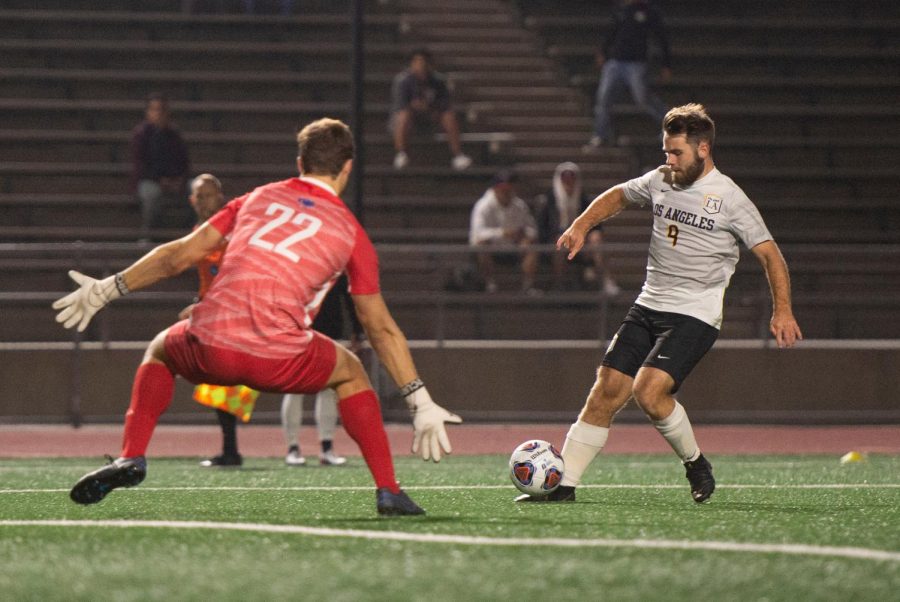 Robin Lindahl (9) defends the ball against his opponent.