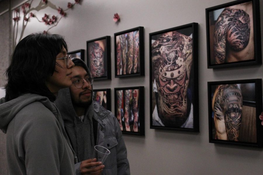 Ruth Gonzalez (left), a Cal State LA chemistry major, and Aaron Tercero (right), a Cal State LA biology chemistry major, view Richard Vasak’s artwork calling it “very beautiful work” during the “Established in Ink” exhibit opening reception.