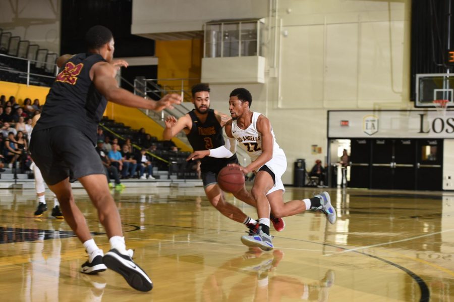 Fard Muhammad (22) defends the ball against Dominguez Hills players in an intense game with Cal State Dominguez Hills.