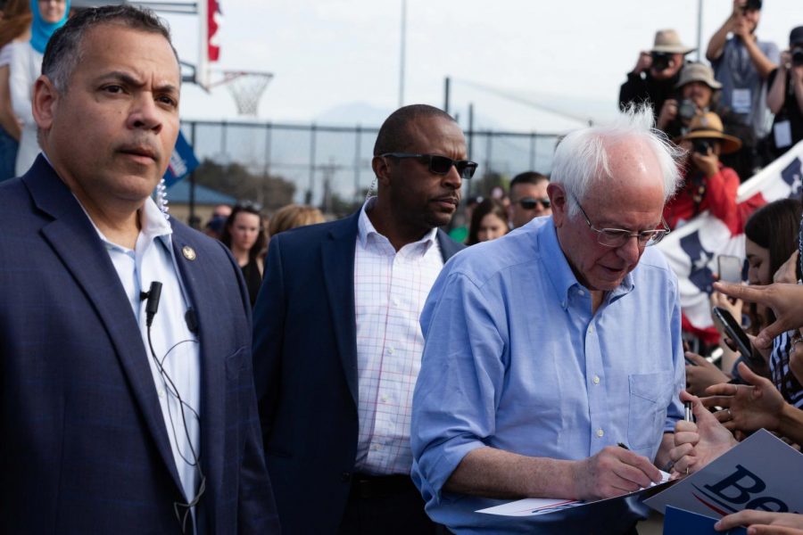 Secret Service security detail follow Sanders as he meets and greets his supporters at the end of the rally.