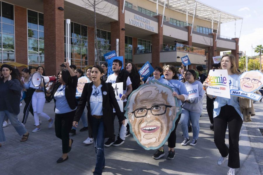 As part of a Sanders campaign event, campus community members gathered in support of the self-labeled democratic socialist, marching from the USU plaza to nearby the voting center on campus.