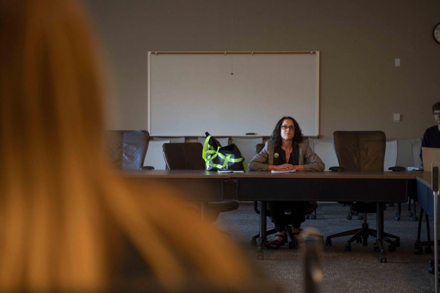 Jonna Fries faces the ASI board as she answers questions about CAPS services.