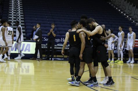 Seniors huddle together as their time runs out with the game clock.