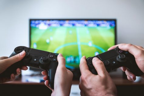 Two hands holding PSP gameschock controls.