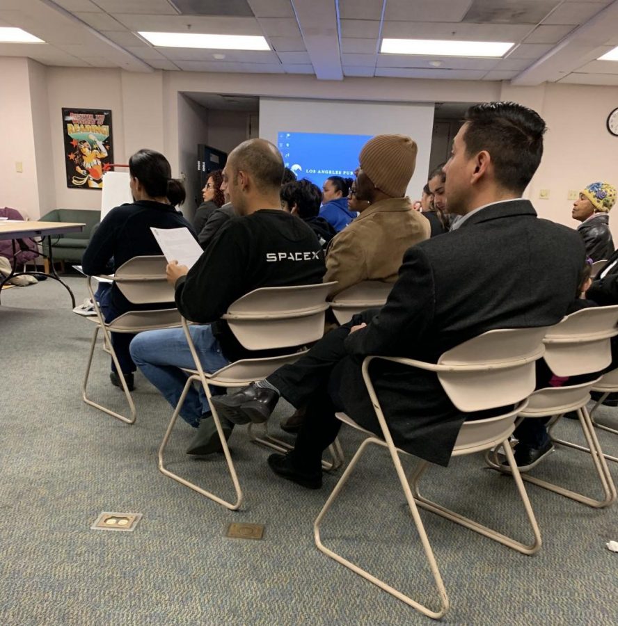 Albert Farias seen among residents in a black suit in Fall 2019