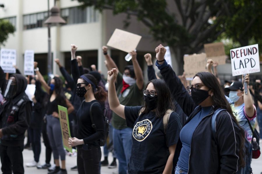 As people gathered at King Hall and prepared to march around campus in solidarity with the ongoing Black Lives Matter movement, they raised their fists in support of the protest that have been going on worldwide for the past two weeks. Photo by Joshua Mejia