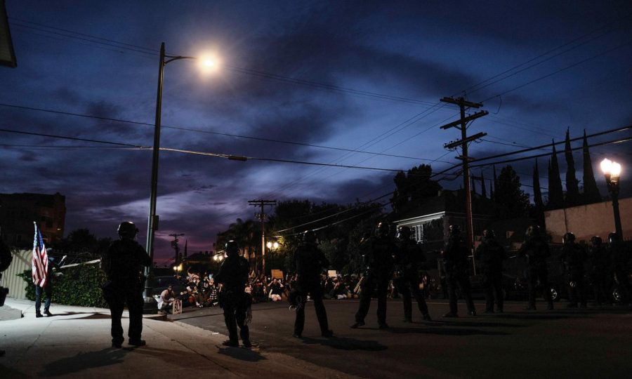 Peaceful protesters kneel with their hands up waiting to get arrested by LAPD near Windsor Square neighborhood in Los Angeles, CALIF on June 2, 2020.