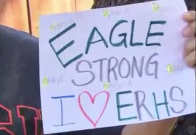 A sign reading Eagle Strong. I love ERHS is held up in this screenshot of a video for the Class of 2020 featuring Eagle Rock teachers and staff.
