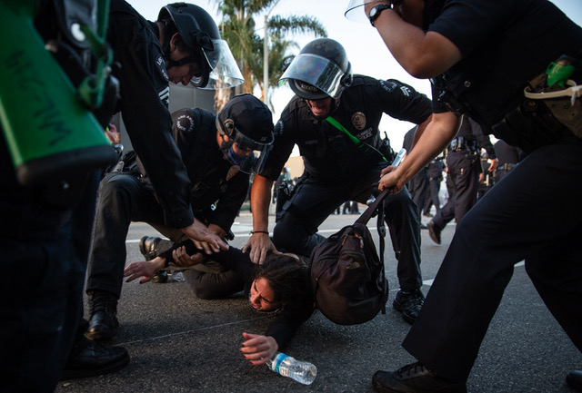 LAPD officers arrest a protester during a demonstration against the killing of George Floyd in police custody. The protest happened in the La Brea district of Los Angeles, California, on May 30, 2020.