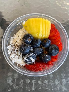 A shot of a bowl of fruit and acai taken from above.