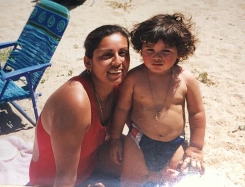 A mother at the beach with her child.