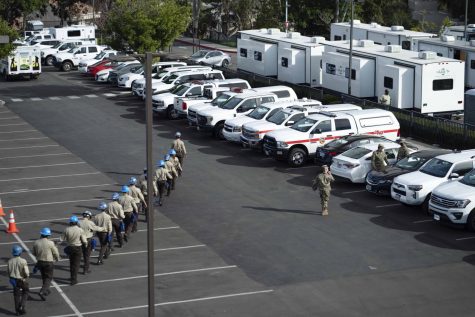 Rows of emergency vehicles can be seen in Parking Lot 5 at Cal State L.A. as military personnel, FEMA, and the California Conservation Corps all gather on campus to set up a vaccination site.