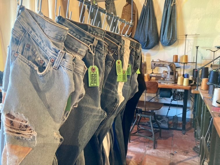 Jeans hang on a rack inside Double-Needle Repair

PC: Jared Everette