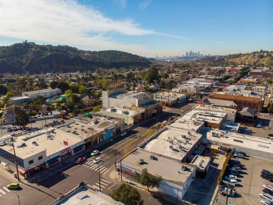 Aerial shot of a commercial strip of shops in Highland Park.