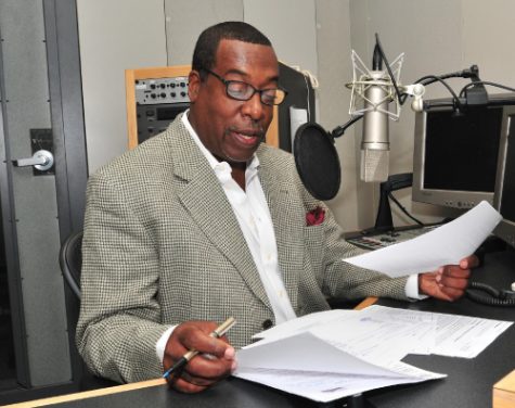 Image of a man talking into a microphone