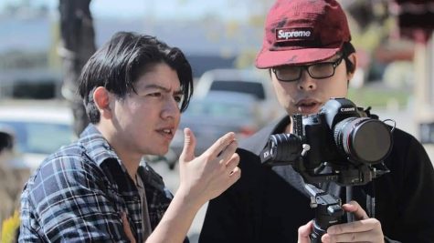 Two men looking at a camera