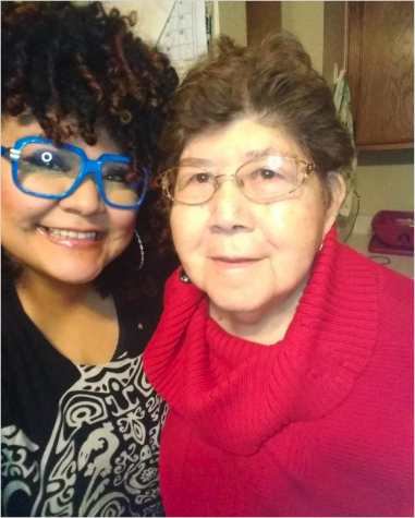 Two women side-by-side, one with blue glasses and another with a red sweater.